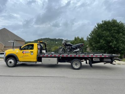 Rayco tow truck towing a motorcycle