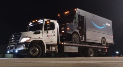 Rayco tow truck towing an Amazon van.